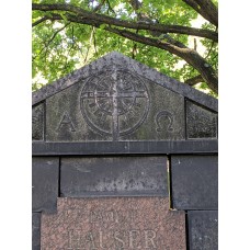 Stylized sun cross, alpha and omega, stone grave monument